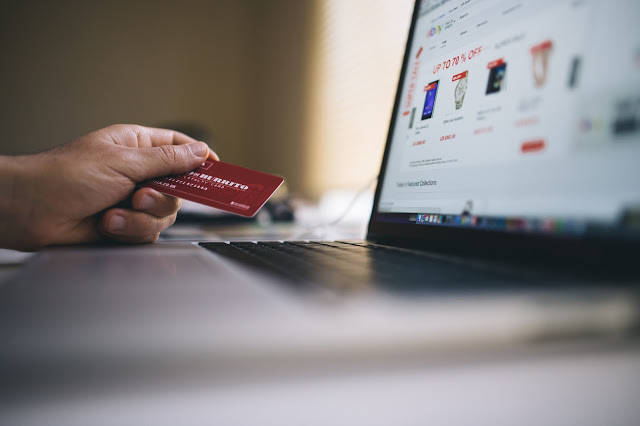 Image of a credit card being used to make an online purchase.